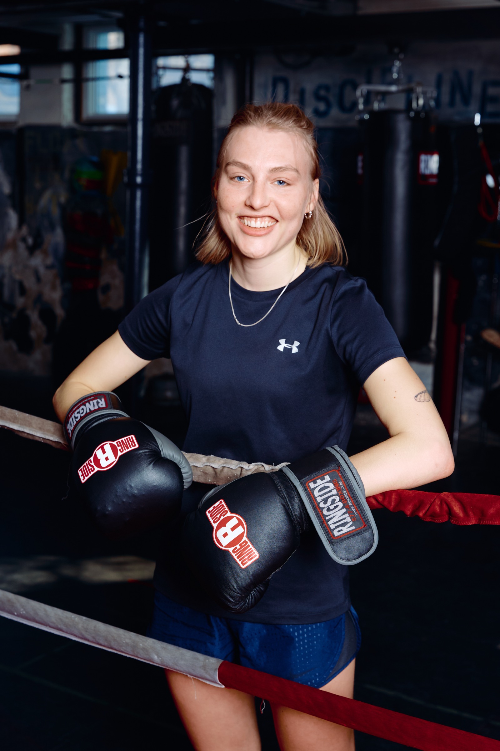 Woman smiling with boxing gloves at Pan Am